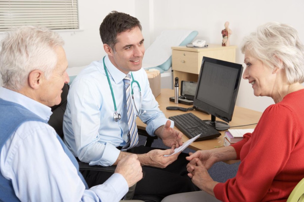 Doctor consulting with patients in a bright private clinic at Alan James Clinics